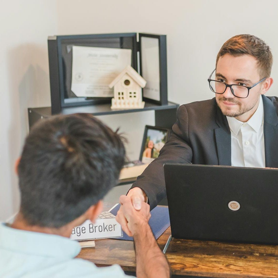 A Mortgage Broker Handshaking with Clients